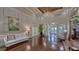 Bright lobby featuring beautiful hardwood floors, detailed trim, an elegant chandelier, and comfortable seating at 6501 Stone River Rd # 304, Bradenton, FL 34203