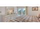 Main bedroom with a large closet, balcony access, and an abundance of natural light at 6501 Stone River Rd # 304, Bradenton, FL 34203