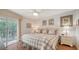 Comfortable main bedroom with balcony access, wood floors, and coastal style decor at 6501 Stone River Rd # 304, Bradenton, FL 34203
