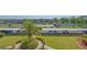 Scenic aerial view of covered parking spots next to manicured landscaping and the community pool at 6501 Stone River Rd # 304, Bradenton, FL 34203