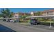 View of covered parking spots with lush landscaping and palm trees at 6501 Stone River Rd # 304, Bradenton, FL 34203