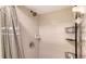 Clean and functional shower stall with tiled walls, modern fixtures, and a storage shelf at 6501 Stone River Rd # 304, Bradenton, FL 34203
