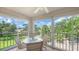Bright sun room showcasing expansive views of the lush greenery and golf course at 6501 Stone River Rd # 304, Bradenton, FL 34203