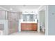 Bright bathroom features a double sink vanity, tiled shower, and separate toilet room at 6618 Grand Estuary Trl # 101, Bradenton, FL 34212