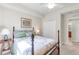 Bedroom with wooden furniture, quilt, side table, and view to adjoining bathroom at 6618 Grand Estuary Trl # 101, Bradenton, FL 34212