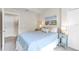 Cozy bedroom with beach themed decor, side tables, and two entry doors at 6618 Grand Estuary Trl # 101, Bradenton, FL 34212