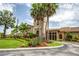 Elegant clubhouse showcases meticulous landscaping and inviting architecture with mature palm trees at 6618 Grand Estuary Trl # 101, Bradenton, FL 34212