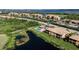 Aerial view of community pool with palm trees, surrounded by beautiful ponds and lush greenery at 6618 Grand Estuary Trl # 101, Bradenton, FL 34212