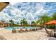 This beautiful community pool has several lounge chairs and is surrounded by palm trees at 6618 Grand Estuary Trl # 101, Bradenton, FL 34212