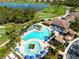 Stunning aerial view of a community pool featuring two separate areas and ample seating around the area at 6618 Grand Estuary Trl # 101, Bradenton, FL 34212