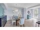 Elegant dining room featuring a modern chandelier, stylish mirror, and ample natural light at 6618 Grand Estuary Trl # 101, Bradenton, FL 34212