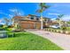 Inviting townhome with a brick driveway, manicured lawn, and a convenient two-car garage at 6618 Grand Estuary Trl # 101, Bradenton, FL 34212