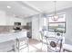 Bright eat-in kitchen featuring white cabinets, stainless steel appliances, and a modern pendant light at 6618 Grand Estuary Trl # 101, Bradenton, FL 34212