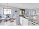 Open concept kitchen features granite counters and eat-in dining with a view at 6618 Grand Estuary Trl # 101, Bradenton, FL 34212