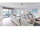Comfortable living room with sliding glass doors leading to a patio and peaceful waterfront views at 6618 Grand Estuary Trl # 101, Bradenton, FL 34212
