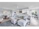 Bright open-concept living room featuring tile floors, comfortable seating, and a view of the kitchen at 6618 Grand Estuary Trl # 101, Bradenton, FL 34212
