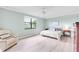Bright main bedroom with plank floors, golf course view, ceiling fan, and elegant furnishings at 6618 Grand Estuary Trl # 101, Bradenton, FL 34212