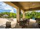 Outdoor seating area overlooking a relaxing pool with overhead lighting and ceiling fan at 6618 Grand Estuary Trl # 101, Bradenton, FL 34212