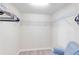 Walk-in closet features wire rack shelving and light plank floors with blue accent chair at 6618 Grand Estuary Trl # 101, Bradenton, FL 34212