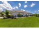 Exterior view of home featuring a lush lawn and mature landscaping in the backyard at 7031 Scrub Jay Dr, Sarasota, FL 34241