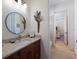 Bathroom with a marble countertop, dark wood cabinets, and decorative elements at 7031 Scrub Jay Dr, Sarasota, FL 34241