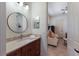 Bathroom with a marble countertop, dark wood cabinets, and decorative elements at 7031 Scrub Jay Dr, Sarasota, FL 34241
