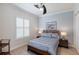 Comfortable bedroom featuring a queen-sized bed, plantation shutters, and stylish decor at 7031 Scrub Jay Dr, Sarasota, FL 34241