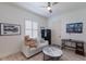 Cozy bedroom with wood floors, a sitting area, and a modern ceiling fan at 7031 Scrub Jay Dr, Sarasota, FL 34241