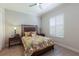 Bright bedroom with wood floors, a queen-sized bed, and plantation shutters at 7031 Scrub Jay Dr, Sarasota, FL 34241
