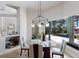 Bright dining area with glass table, pendant lighting, and a view of the pool area at 7031 Scrub Jay Dr, Sarasota, FL 34241