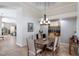 Formal dining room featuring a round table, elegant chandelier, and contemporary artwork, perfect for entertaining at 7031 Scrub Jay Dr, Sarasota, FL 34241