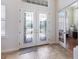 Elegant foyer with decorative tile flooring and glass-paneled double doors leading to a bright, welcoming interior at 7031 Scrub Jay Dr, Sarasota, FL 34241