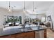 Open concept kitchen with island, pendant lights, stainless steel appliances, and a view of the living area at 7031 Scrub Jay Dr, Sarasota, FL 34241
