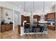 Spacious kitchen with a large island, dark countertops, pendant lighting and stainless steel appliances at 7031 Scrub Jay Dr, Sarasota, FL 34241