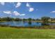 Scenic view of the community lake with lush green grass at 7031 Scrub Jay Dr, Sarasota, FL 34241
