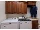 Convenient laundry room featuring cabinetry, a sink, and modern appliances at 7031 Scrub Jay Dr, Sarasota, FL 34241