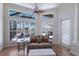 Bright main bedroom seating area features a view of the pool, wood floors, and plantation shutters at 7031 Scrub Jay Dr, Sarasota, FL 34241