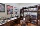 Well-appointed home office with rich wood finishes, built-in shelving, and a comfortable executive chair at 7031 Scrub Jay Dr, Sarasota, FL 34241