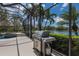 Outdoor stainless steel grill on the screened in patio offers views of the lake at 7031 Scrub Jay Dr, Sarasota, FL 34241