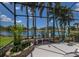 Beautiful screened-in pool and patio area with serene lake views and lush greenery at 7031 Scrub Jay Dr, Sarasota, FL 34241