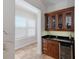 Convenient wet bar featuring a sink, wine cooler, and elegant cabinetry for entertaining guests at 7031 Scrub Jay Dr, Sarasota, FL 34241