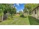 A partially shaded backyard with a wood fence border and lush green lawn at 7142 Bright Creek Dr # 35, Sarasota, FL 34231