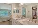 Bright bathroom with double sink vanity and mirrors overlooking the Primary bedroom at 7142 Bright Creek Dr # 35, Sarasota, FL 34231