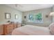 Bedroom featuring a comfy bed, large window, and a dresser with ample storage at 7142 Bright Creek Dr # 35, Sarasota, FL 34231