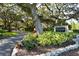 A lush community entrance with a Woodside South sign at 7142 Bright Creek Dr # 35, Sarasota, FL 34231