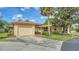 Single story home with a one-car garage, neutral paint, brick path and mature landscaping at 7142 Bright Creek Dr # 35, Sarasota, FL 34231