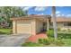 Charming home with a one-car garage and inviting entrance, framed by lush landscaping at 7142 Bright Creek Dr # 35, Sarasota, FL 34231