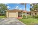 Charming home with a one-car garage and inviting entrance, framed by lush landscaping at 7142 Bright Creek Dr # 35, Sarasota, FL 34231