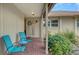 Inviting front porch with brick flooring, chairs, and a decorative wreath on the front door at 7142 Bright Creek Dr # 35, Sarasota, FL 34231
