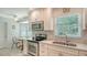 Bright kitchen with stainless steel appliances, white cabinetry, and a cozy breakfast nook at 7142 Bright Creek Dr # 35, Sarasota, FL 34231